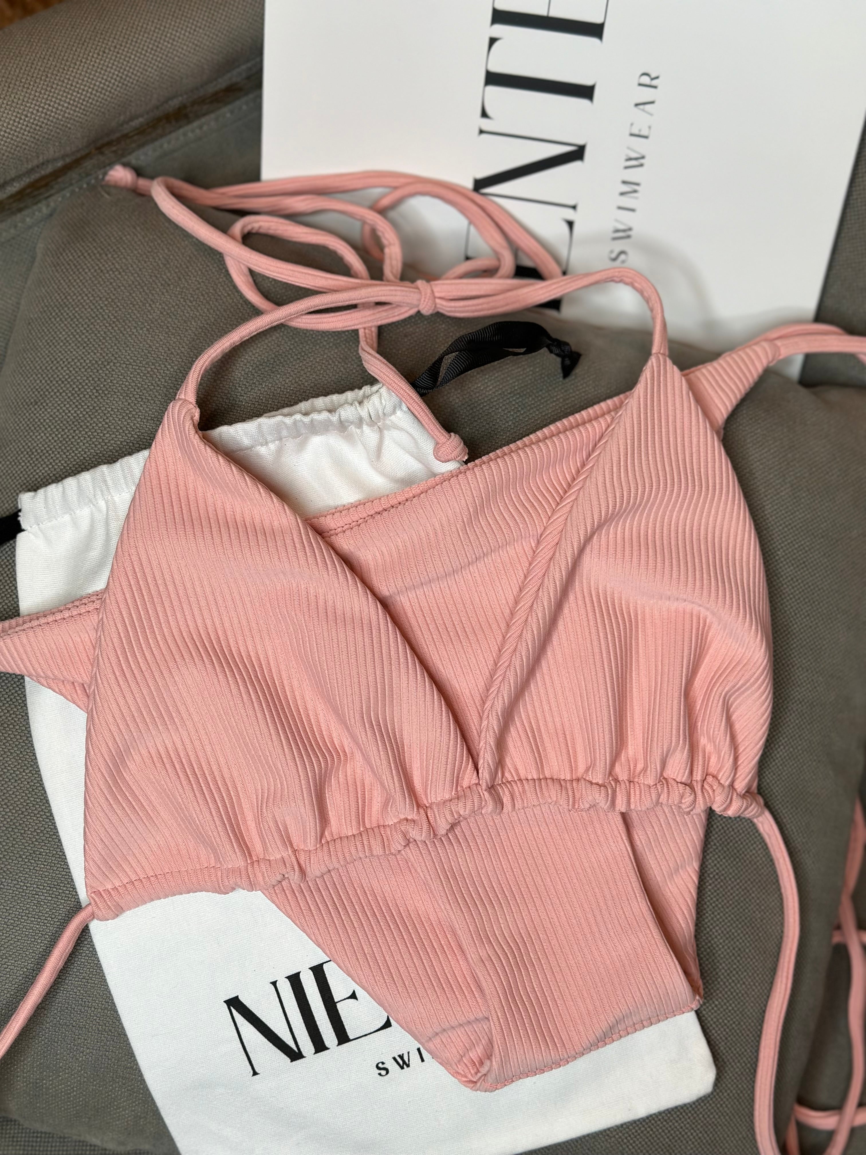 Immerse yourself in the confidence of a truly versatile piece, designed to elevate your beach style to unparalleled heights. The sleek, classic pink bikini isn't just a choice; it's a statement. With its refined simplicity, it becomes the canvas upon which you paint your own seaside narrative.